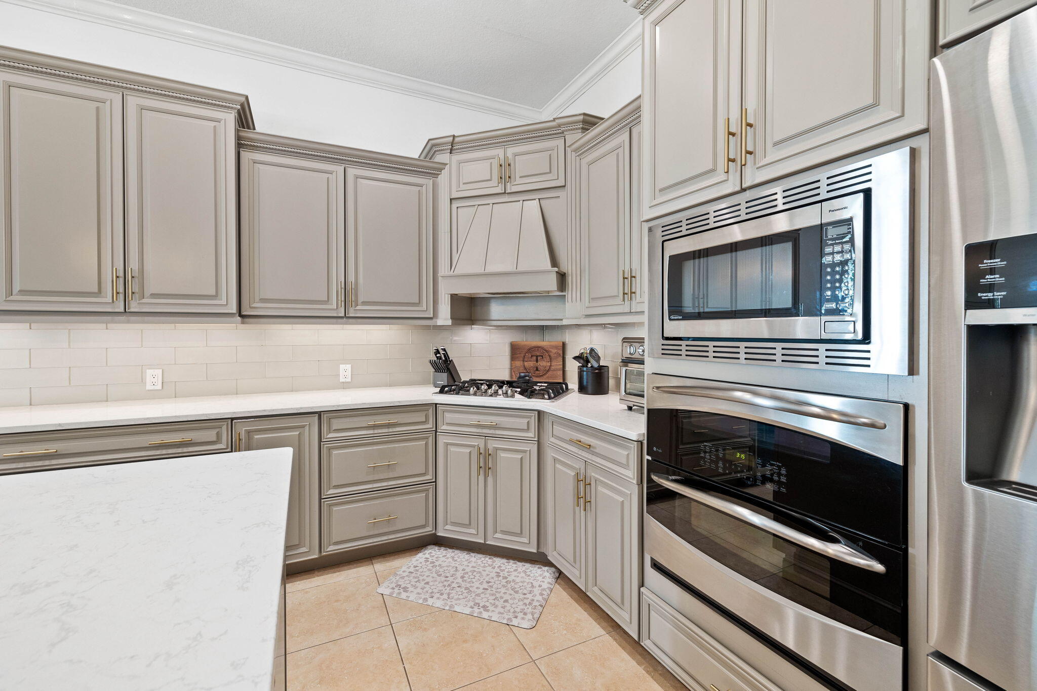 201 Mattie's Way Destin, FL 32541 - Photo 12 of 61 a kitchen with cabinets stainless steel appliances and sink