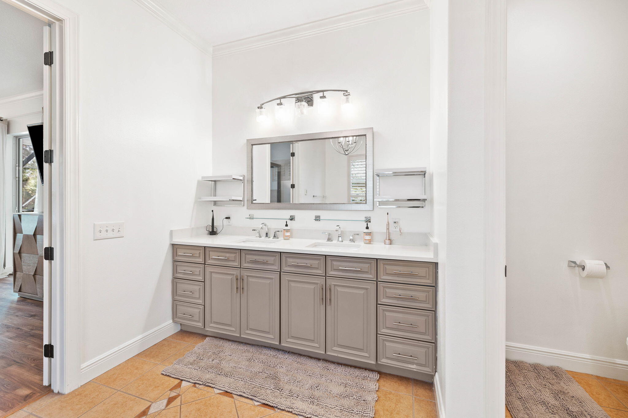 201 Mattie's Way Destin, FL 32541 - Photo 23 of 61 a bathroom with a sink and a mirror