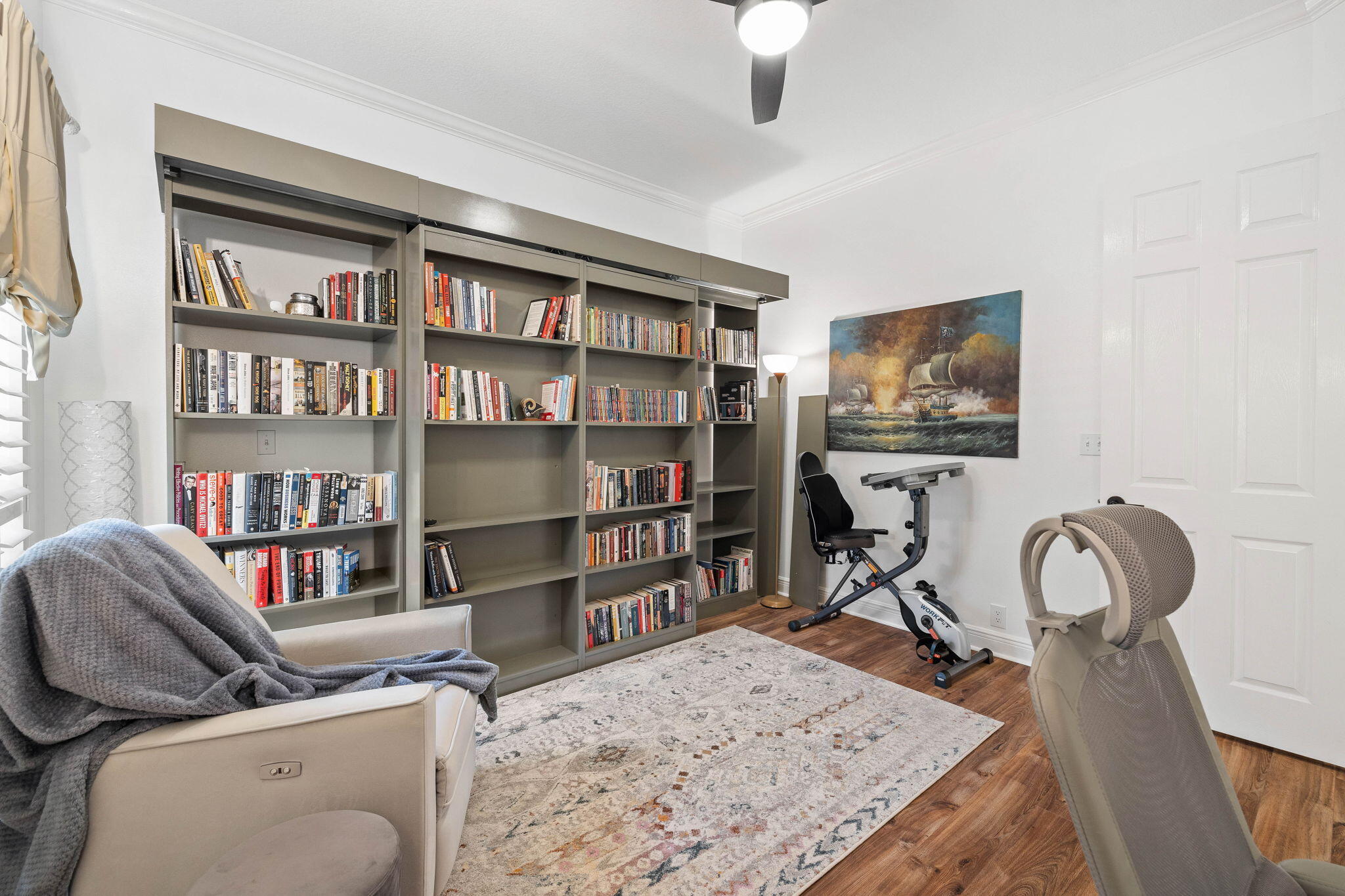 201 Mattie's Way Destin, FL 32541 - Photo 25 of 61 a view of a workspace with furniture and a bookshelf