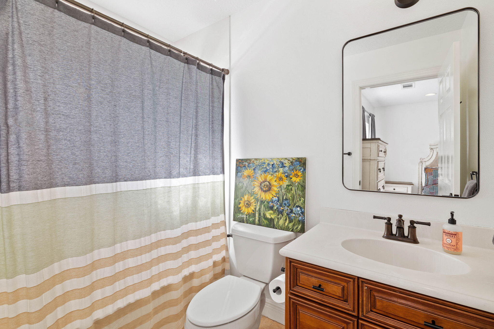 201 Mattie's Way Destin, FL 32541 - Photo 33 of 61 a bathroom with a sink vanity mirror and toilet