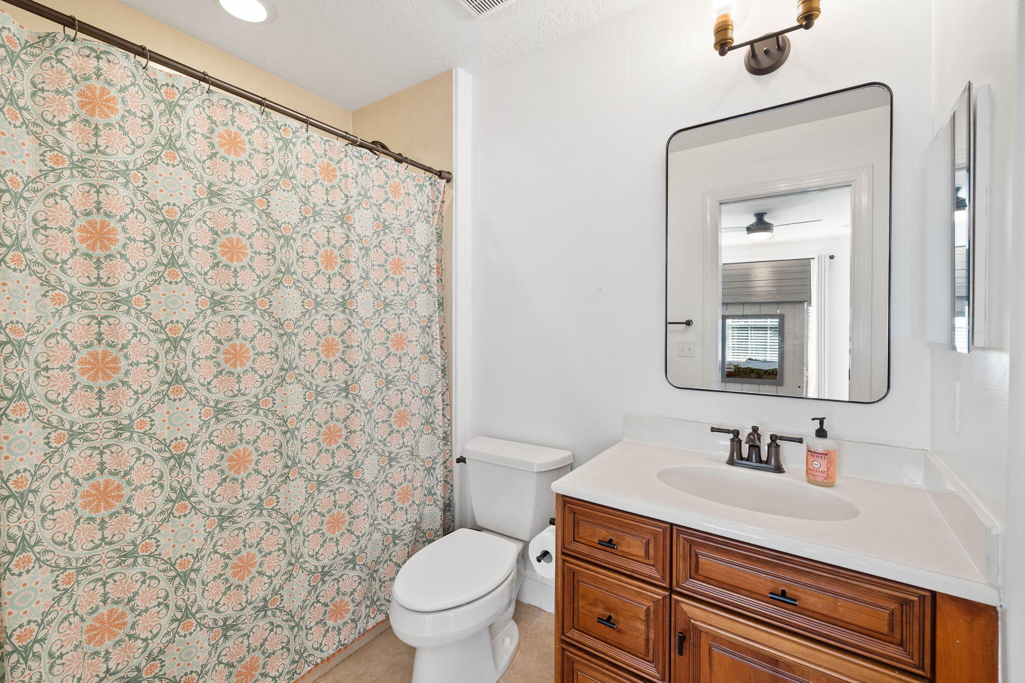 201 Mattie's Way Destin, FL 32541 - Photo 37 of 61 a bathroom with a granite countertop toilet sink and a mirror