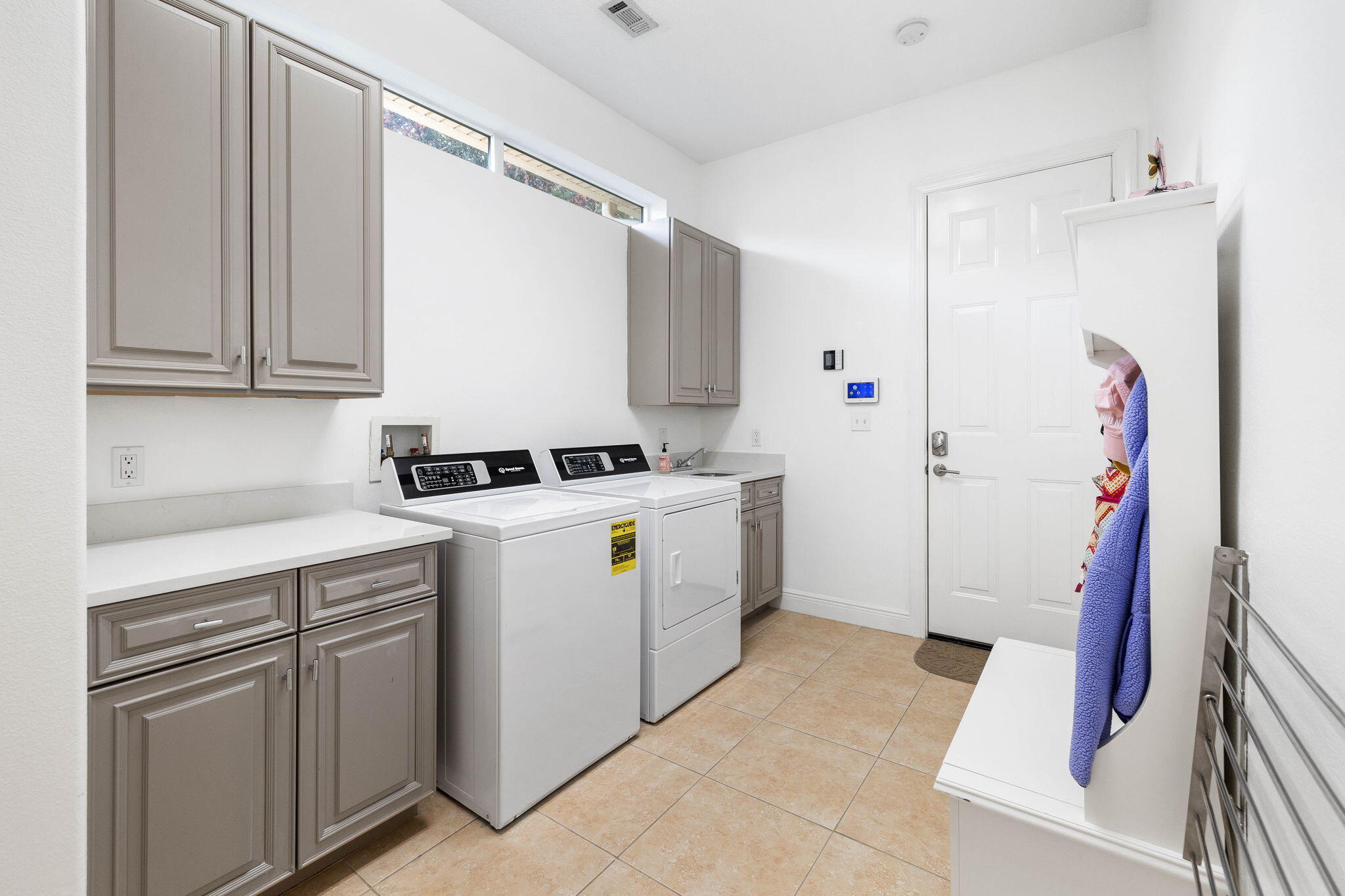 201 Mattie's Way Destin, FL 32541 - Photo 38 of 61 a utility room with cabinets washer and dryer