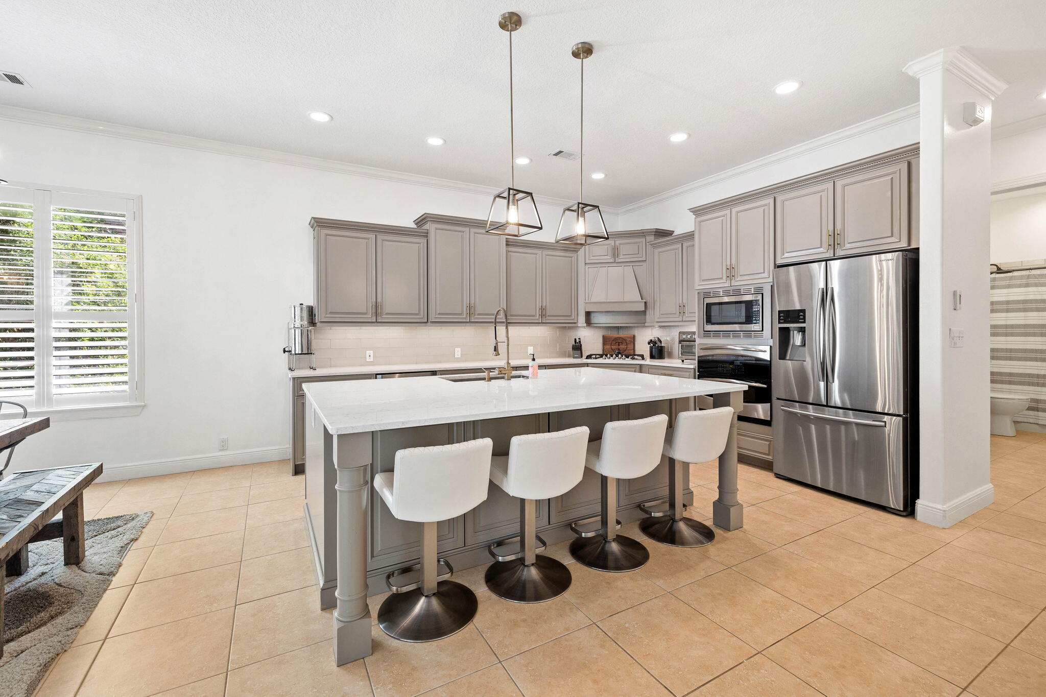 201 Mattie's Way Destin, FL 32541 - Photo 9 of 61 a kitchen with stainless steel appliances a table chairs refrigerator and microwave