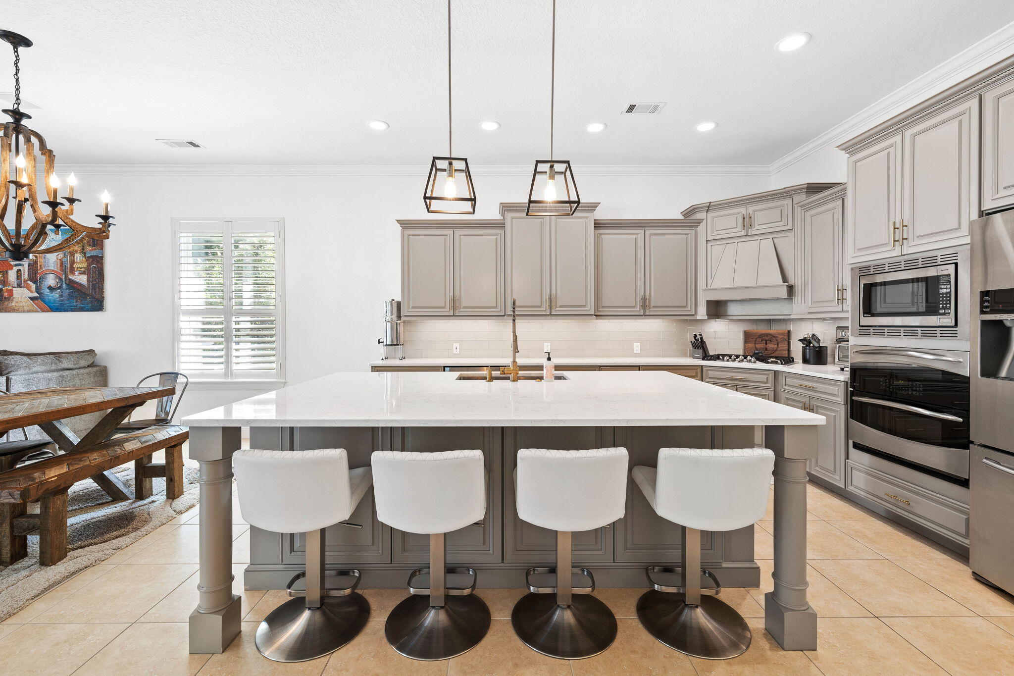 201 Mattie's Way Destin, FL 32541 - Photo 10 of 61 a kitchen with a sink and chairs