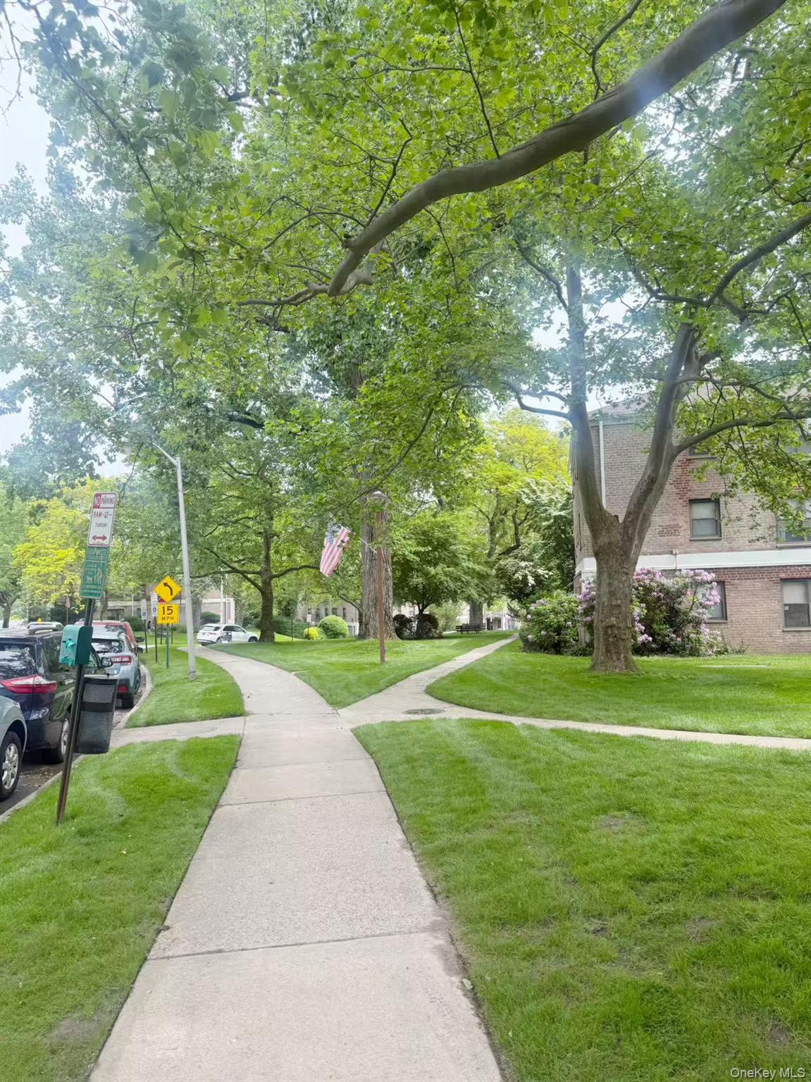 46 Terrace Circle, Unit 2C Great Neck, NY 11021 - Photo 3 of 14 View of home's community with a lawn