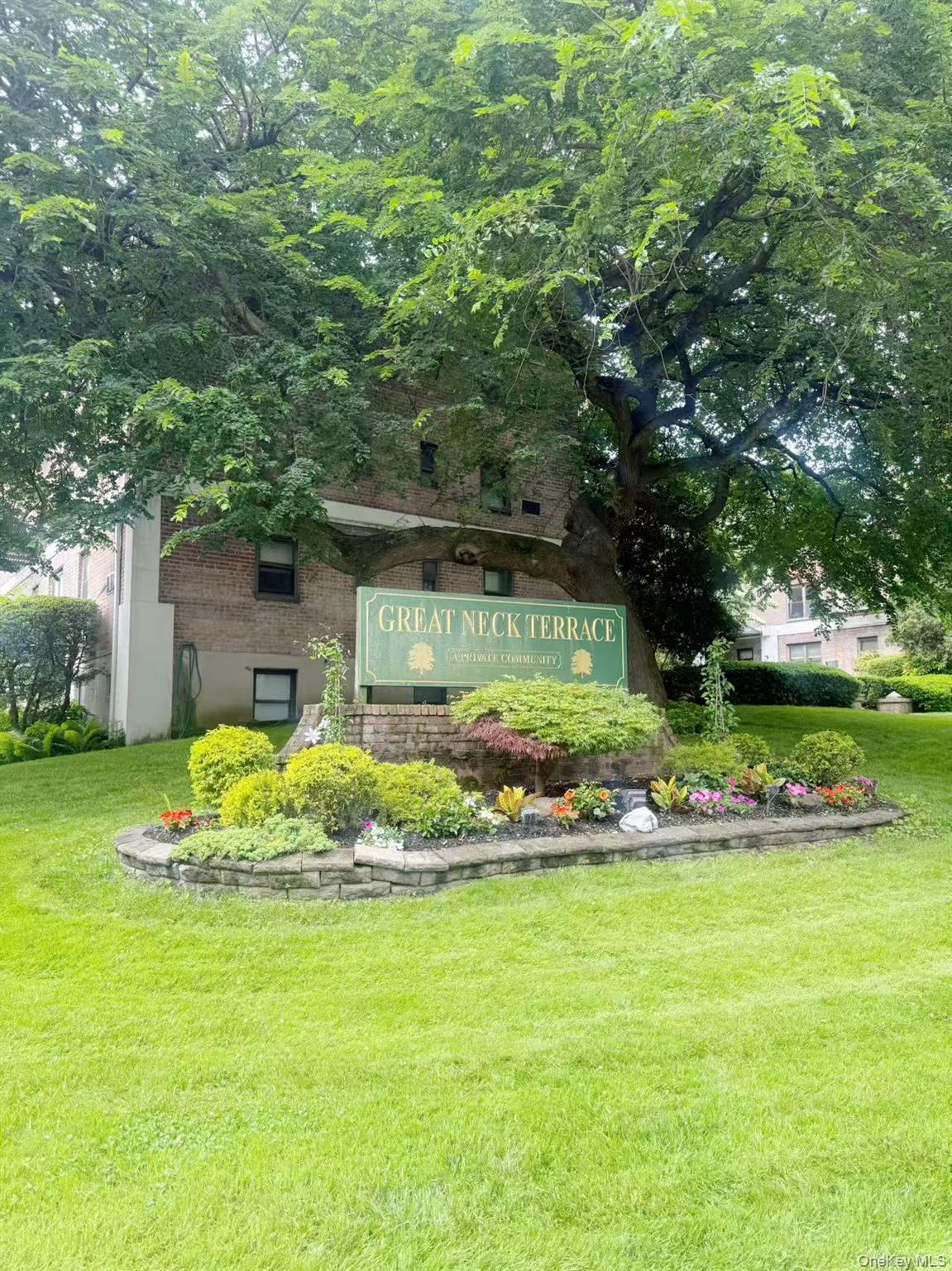 46 Terrace Circle, Unit 2C Great Neck, NY 11021 - Photo 4 of 14 Community sign featuring a yard