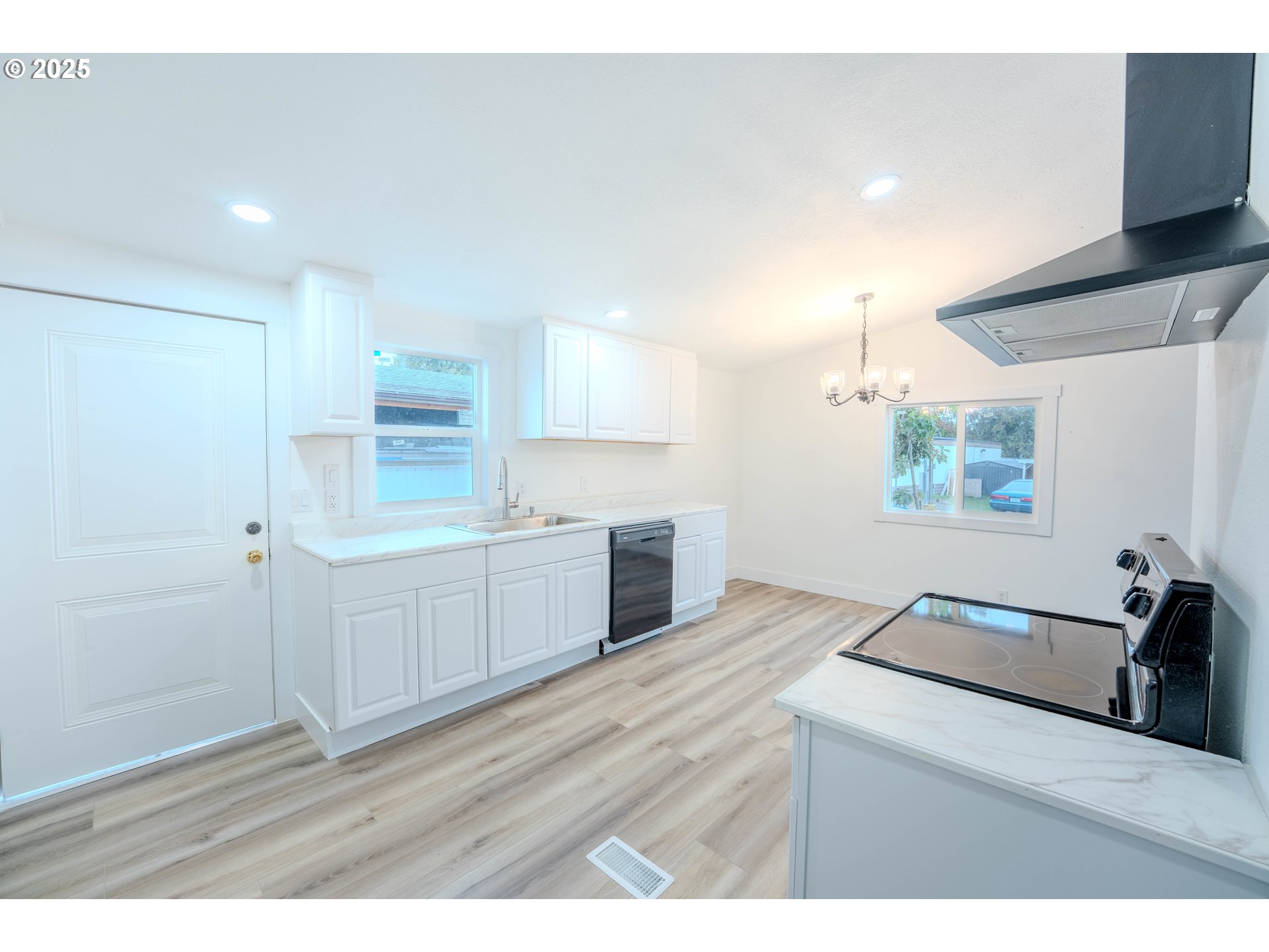 3370 Maple Street, Unit 44 Hubbard, OR 97032 - Photo 11 of 29 a kitchen with a sink cabinets and wooden floor