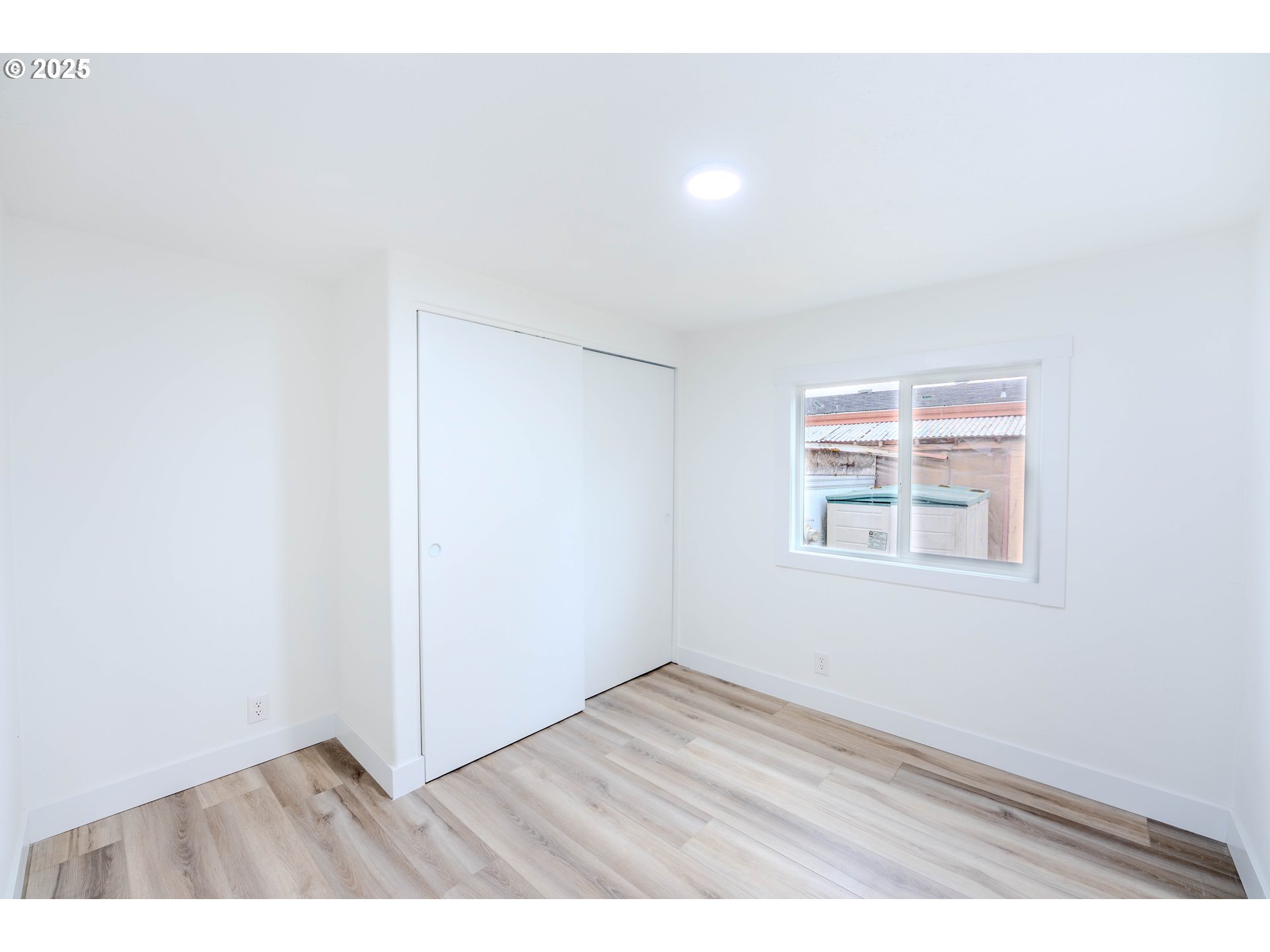 3370 Maple Street, Unit 44 Hubbard, OR 97032 - Photo 15 of 29 an empty room with wooden floor and windows