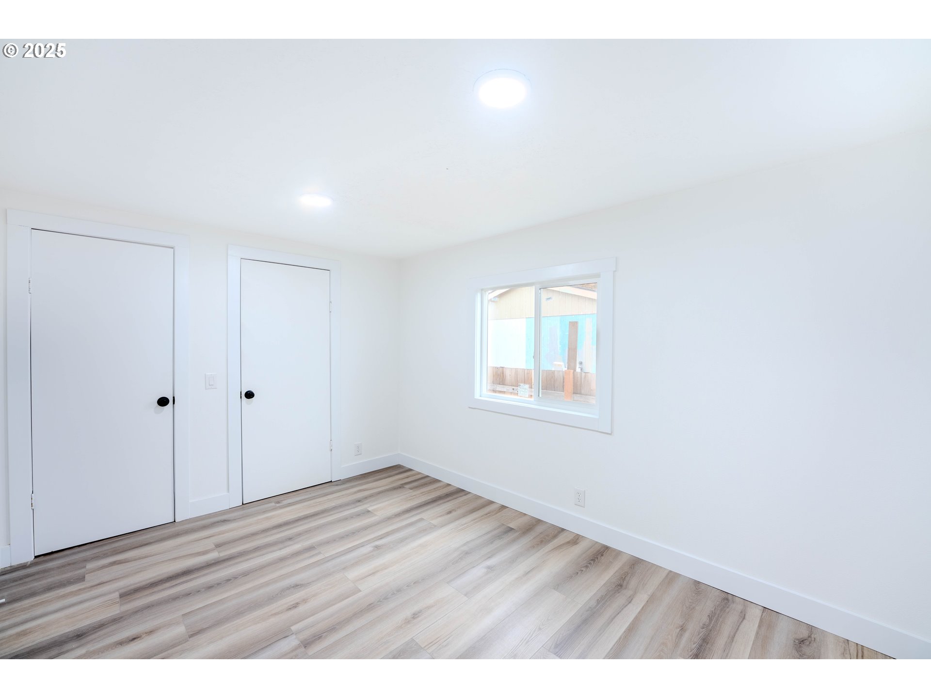 3370 Maple Street, Unit 44 Hubbard, OR 97032 - Photo 19 of 29 a view of an empty room with wooden floor and a window