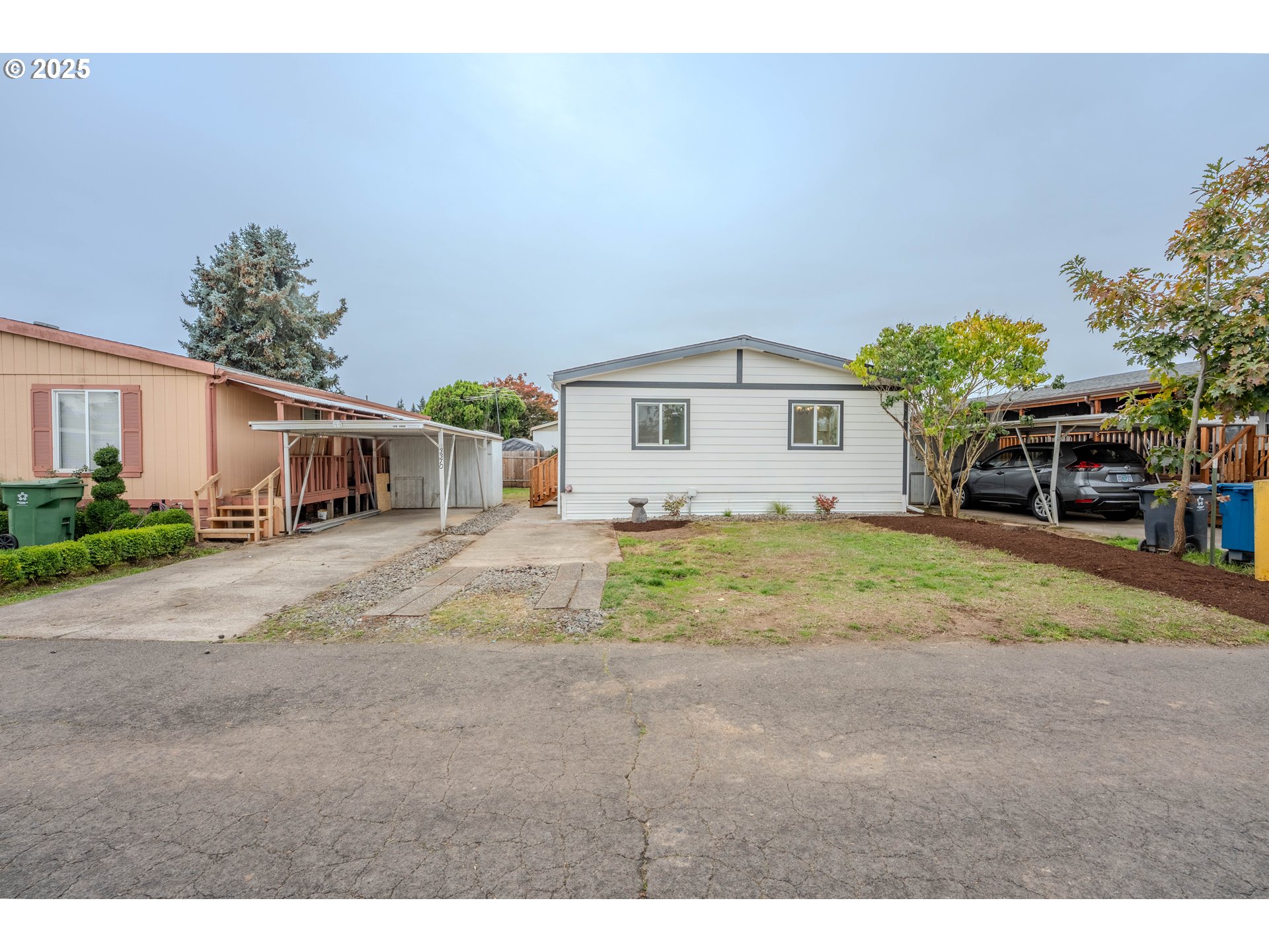 3370 Maple Street, Unit 44 Hubbard, OR 97032 - Photo 4 of 29 a front view of a house with a yard and garage