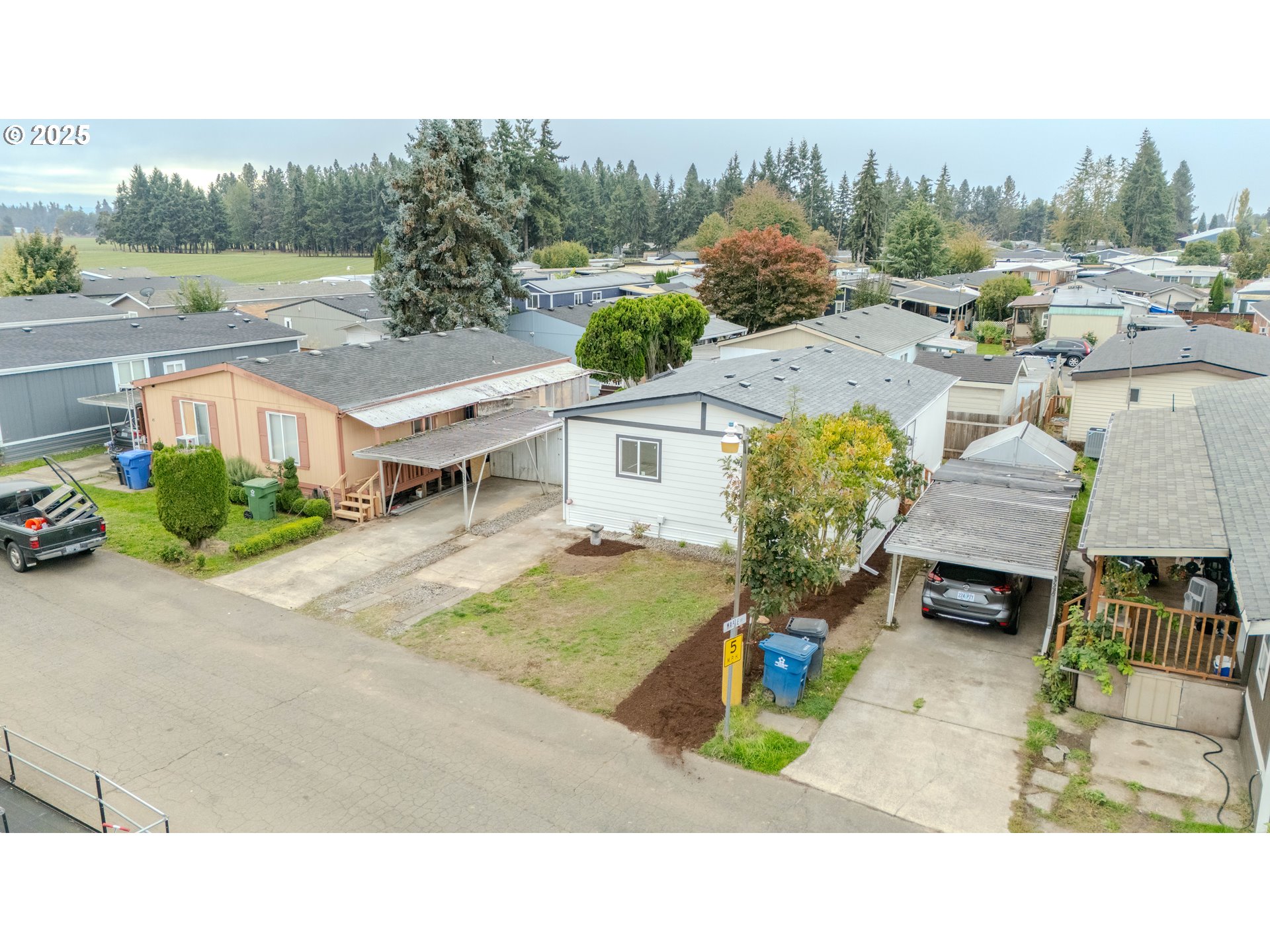 3370 Maple Street, Unit 44 Hubbard, OR 97032 - Photo 5 of 29 a view of a terrace with a garden and trees
