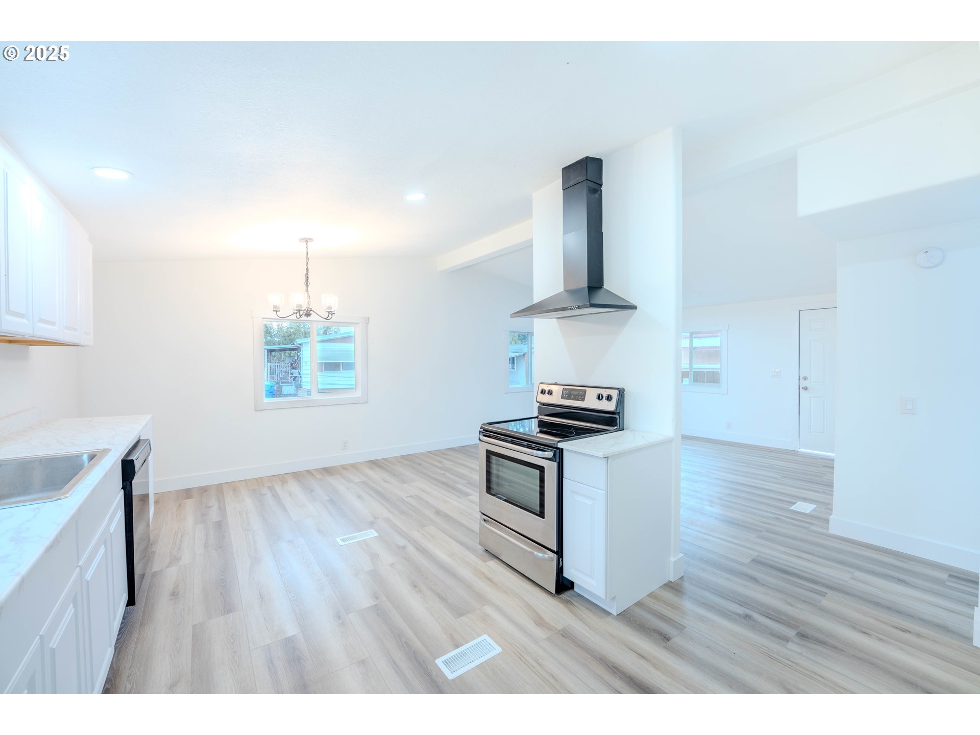 3370 Maple Street, Unit 44 Hubbard, OR 97032 - Photo 10 of 29 a open kitchen with cabinets and wooden floor