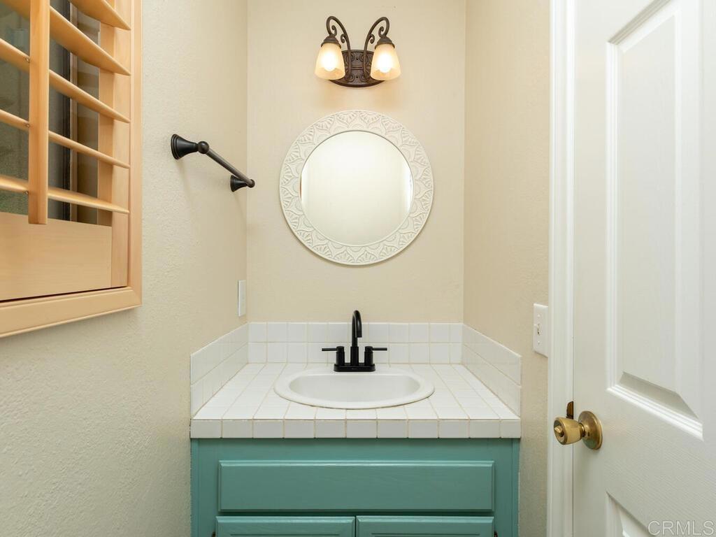 1718 Tecalote Drive, Unit 14 Fallbrook, CA 92028 - Photo 17 of 40 a bathroom with a sink and a mirror