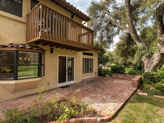 a backyard of a house with a yard and outdoor seating