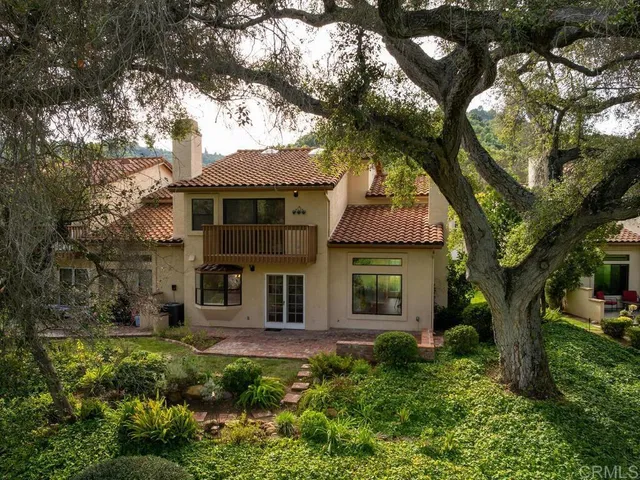 front view of a house with a tree