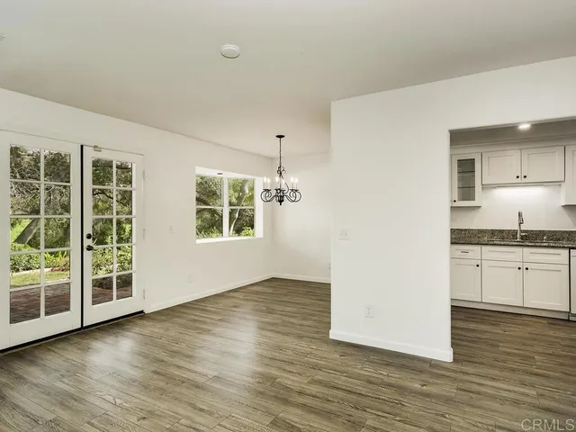 a kitchen with a sink granite counter tops and a wooden floors