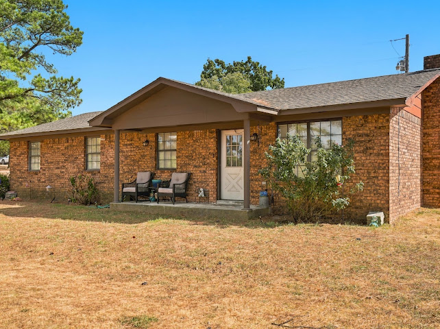 30063 South 4300th Road Stigler, OK 74462 - Photo 4 of 58 Brick exterior with a covered front porch and a gabled roofline