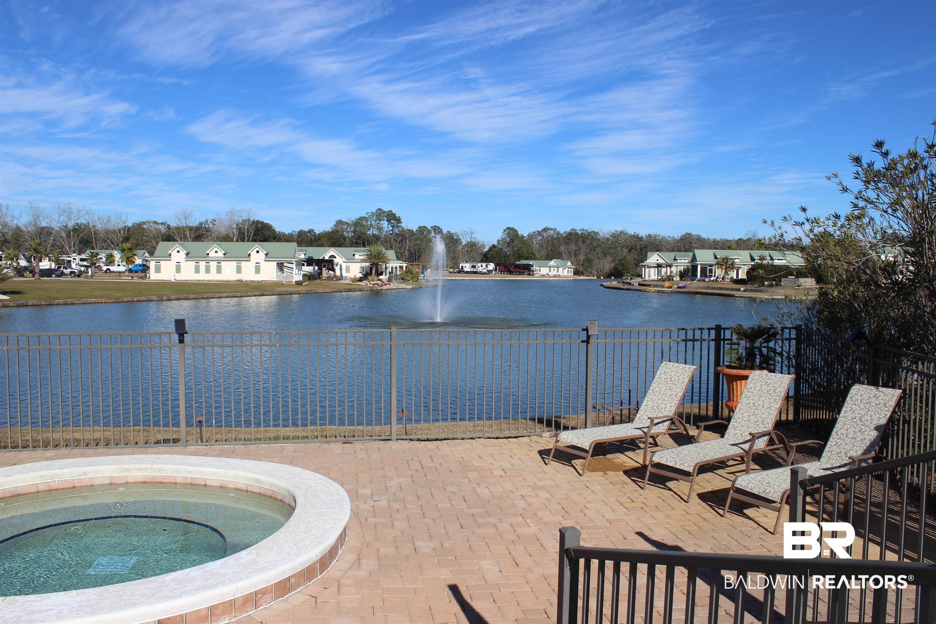 12451 Gateway Drive Elberta, AL 36530 - Photo 24 of 47 View of swimming pool featuring a water view, an in-ground hot tub, and a patio