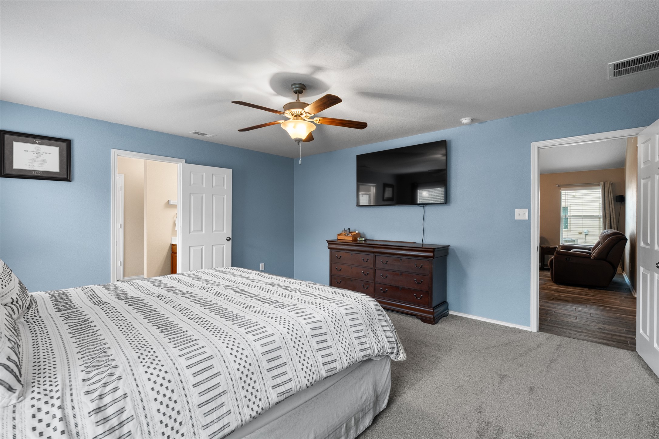 137 Barn Owl Loop Leander, TX 78641 - Photo 21 of 36 a bedroom with a bed and a flat screen tv