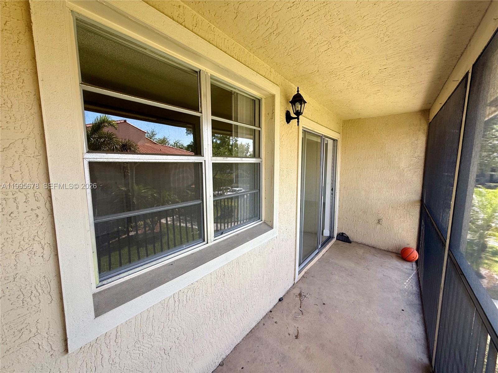 1253 Southwest 46th Avenue, Unit 1608 Pompano Beach, FL 33069 - Photo 12 of 14 a view of an empty room with a window