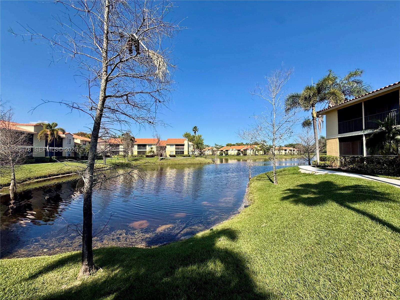 1253 Southwest 46th Avenue, Unit 1608 Pompano Beach, FL 33069 - Photo 14 of 14 a swimming pool with outdoor seating and yard