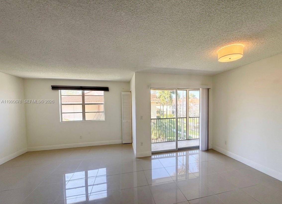 1253 Southwest 46th Avenue, Unit 1608 Pompano Beach, FL 33069 - Photo 3 of 14 an empty room with windows