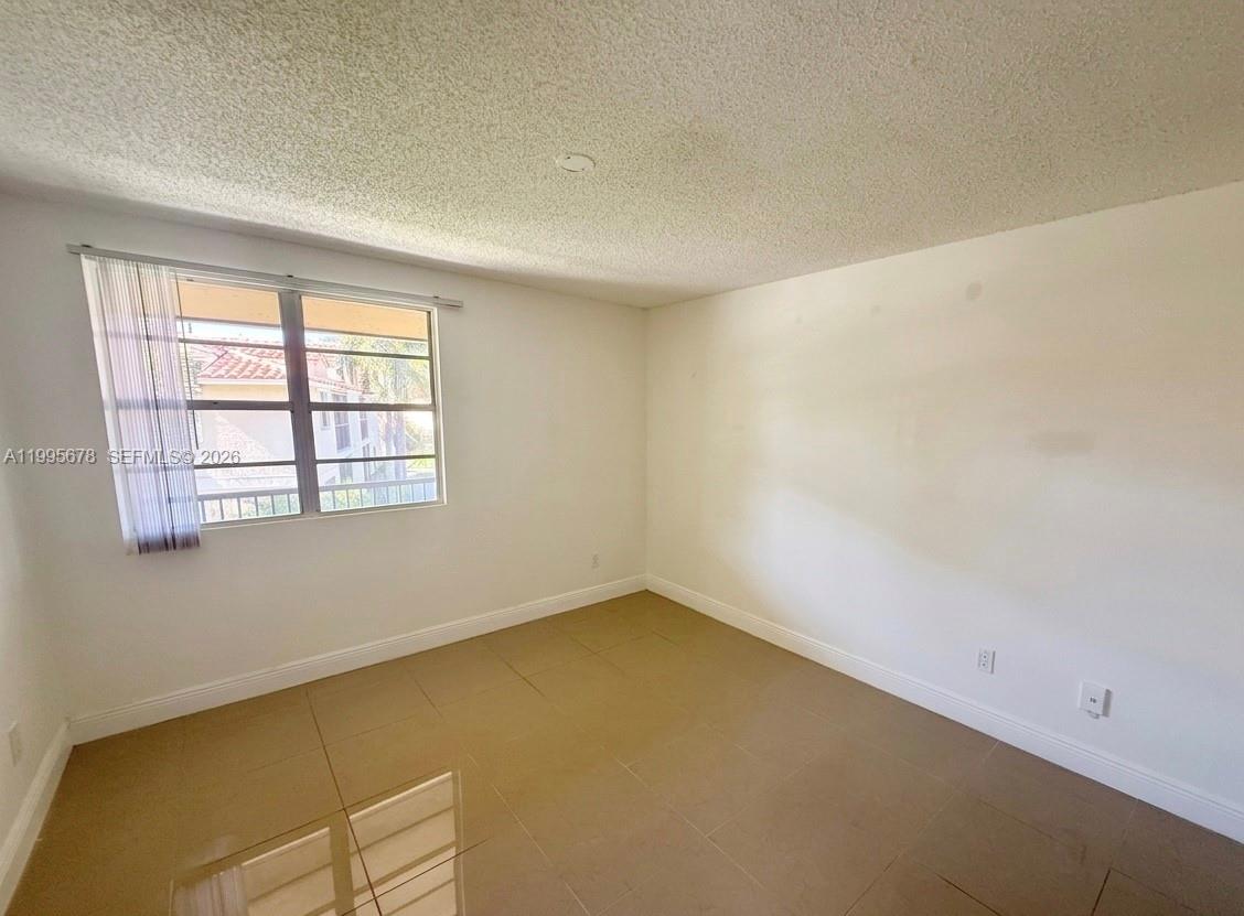 1253 Southwest 46th Avenue, Unit 1608 Pompano Beach, FL 33069 - Photo 8 of 14 an empty room with a windows