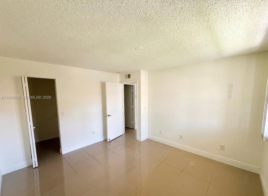 1253 Southwest 46th Avenue, Unit 1608 Pompano Beach, FL 33069 - Photo 10 of 14 an empty room with closet