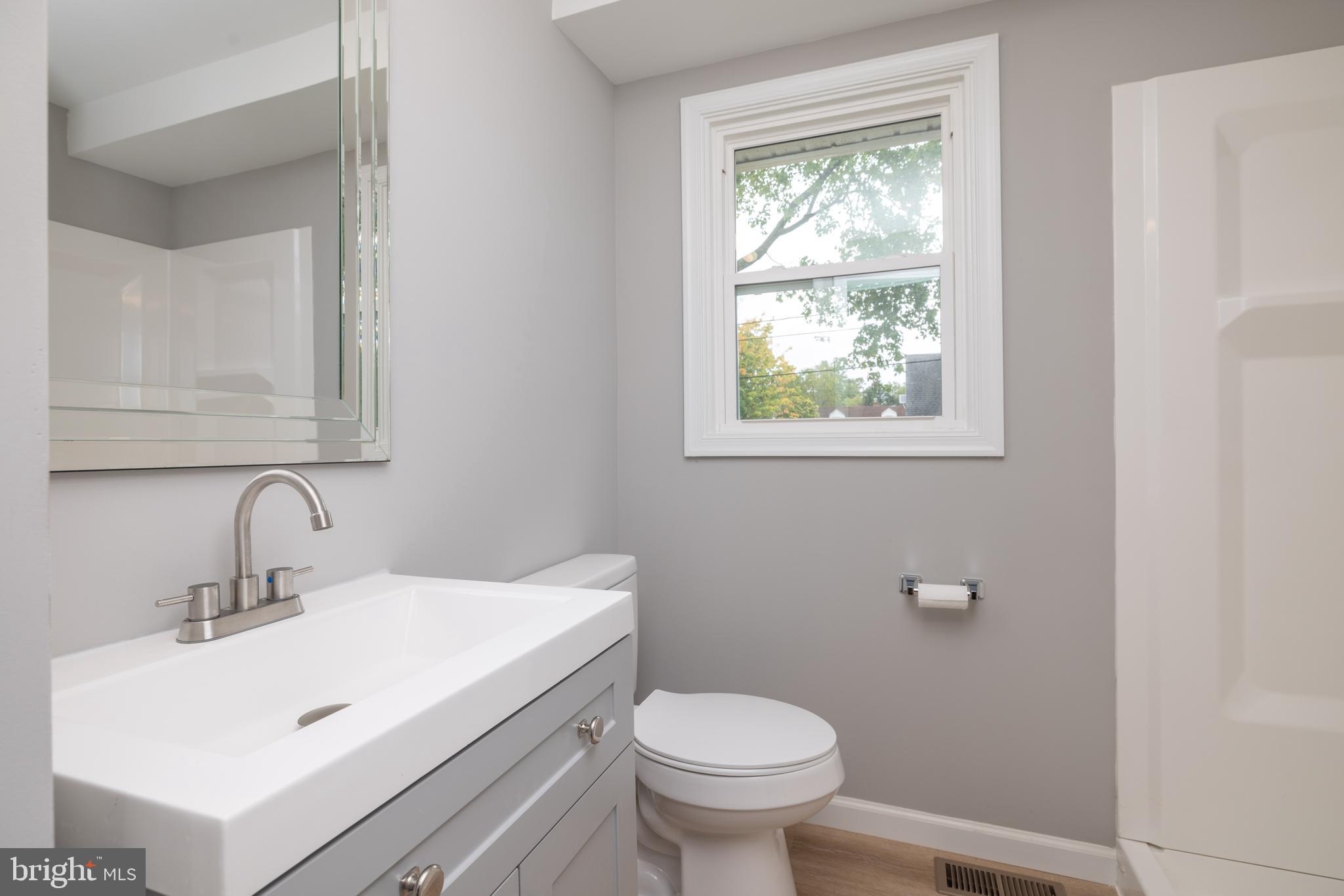 110 Old Point Road Wilmington, DE 19803 - Photo 12 of 27 a bathroom with a sink toilet and a window