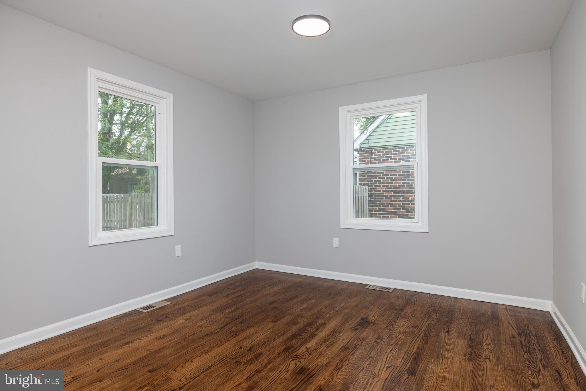 110 Old Point Road Wilmington, DE 19803 - Photo 13 of 27 an empty room with wooden floor and windows