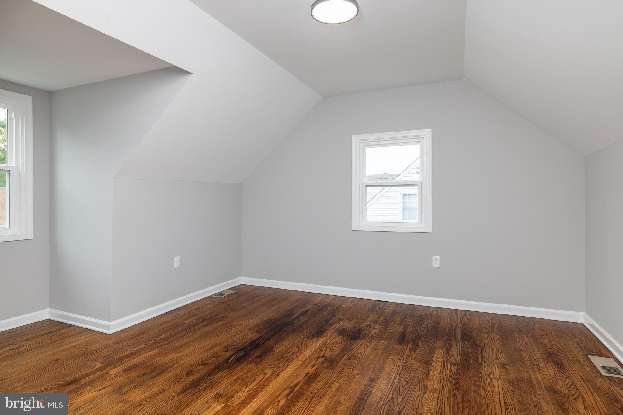 110 Old Point Road Wilmington, DE 19803 - Photo 17 of 27 an empty room with wooden floor and windows