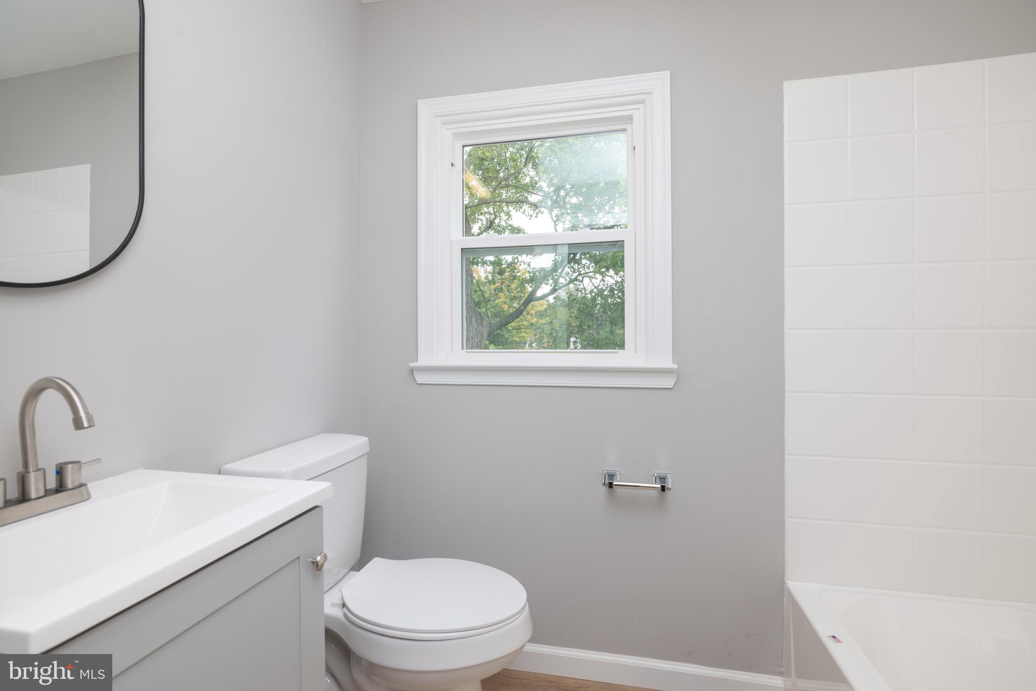 110 Old Point Road Wilmington, DE 19803 - Photo 20 of 27 a bathroom with a toilet a sink and a window