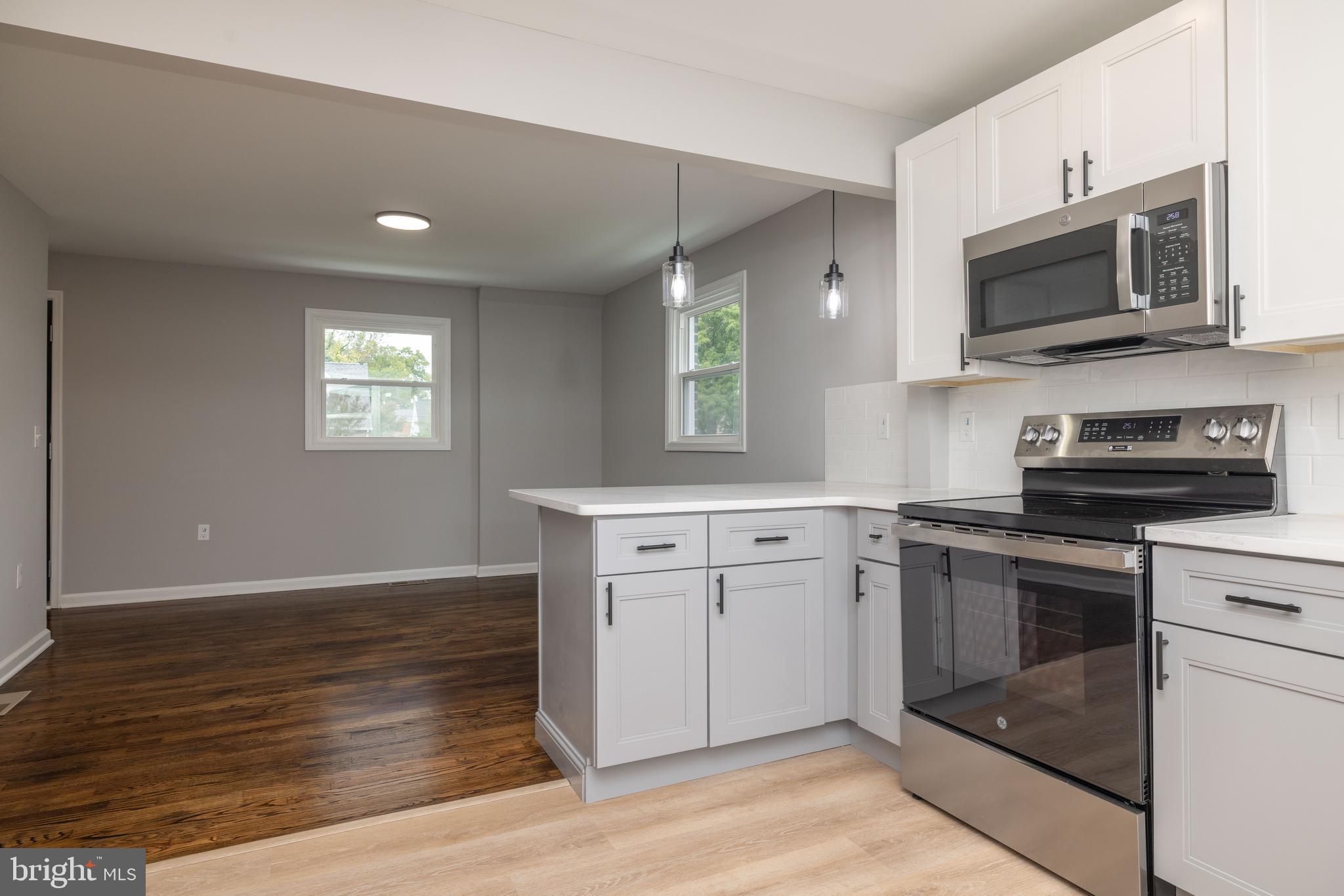 110 Old Point Road Wilmington, DE 19803 - Photo 5 of 27 a kitchen with stainless steel appliances granite countertop a stove a sink and a microwave