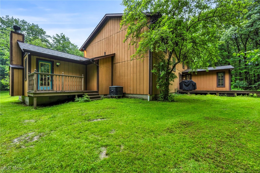 12938 Carter Road Painesville, OH 44077 - Photo 45 of 50 Rear view of property with a chimney, a yard, and a deck