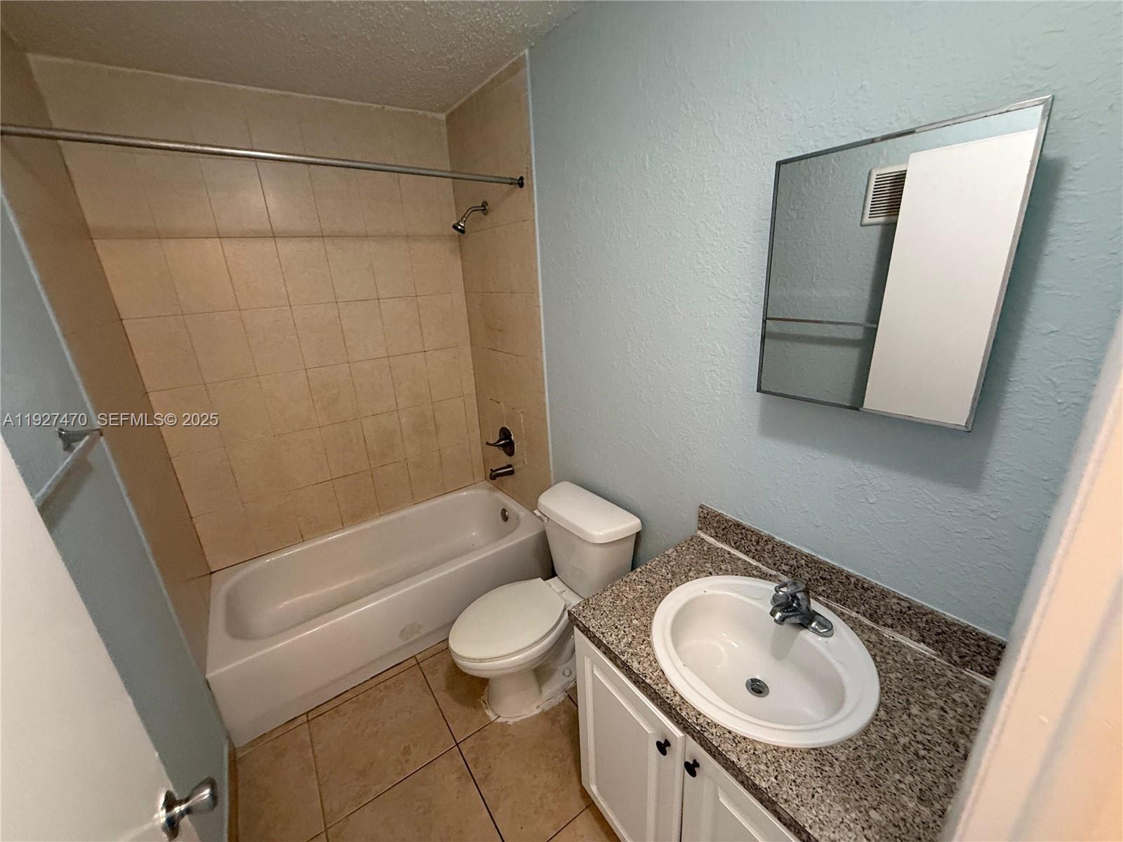 400 Northwest 65th Avenue, Unit 227 Margate, FL 33063 - Photo 5 of 13 a bathroom with a sink toilet and shower