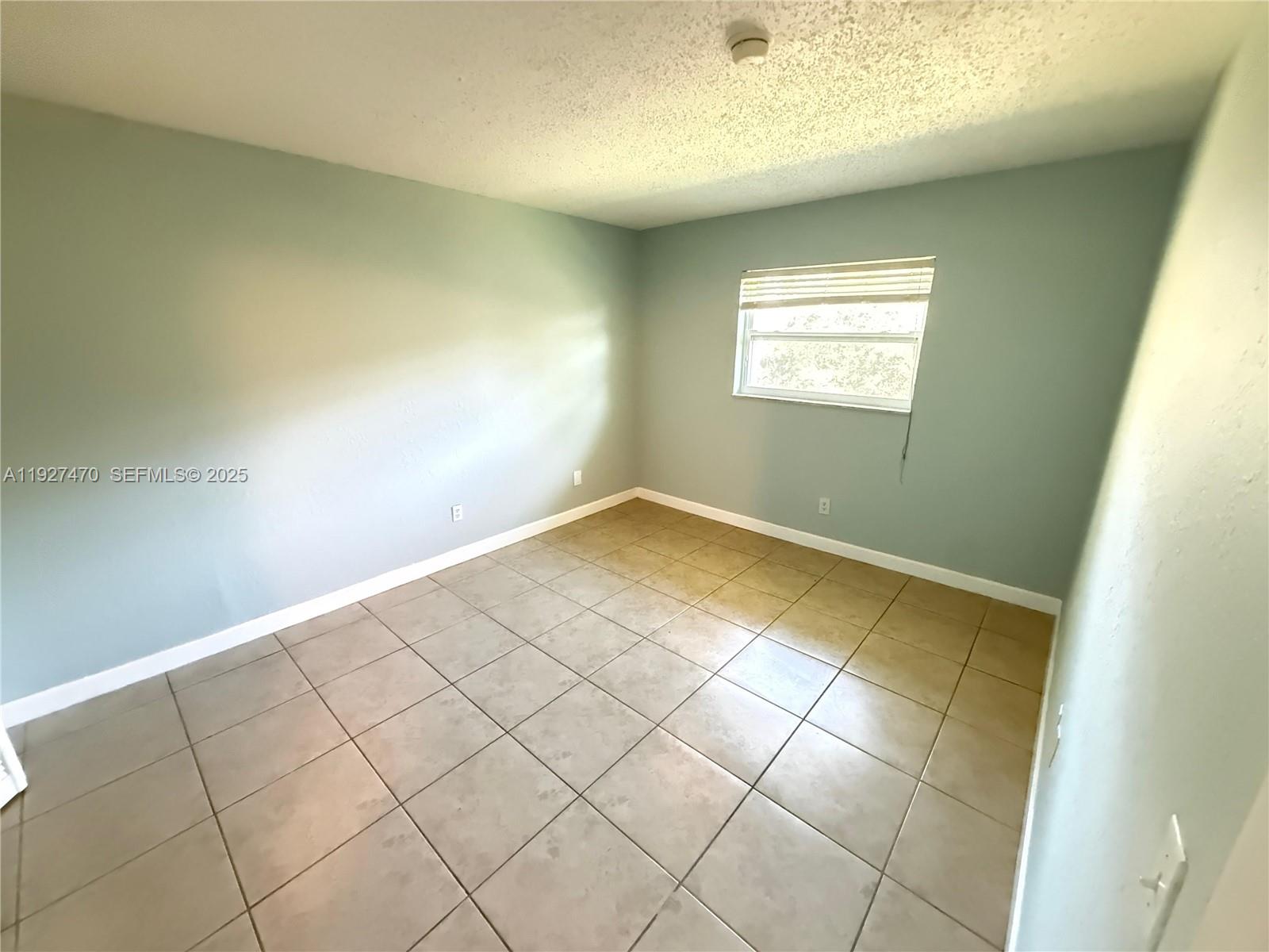 400 Northwest 65th Avenue, Unit 227 Margate, FL 33063 - Photo 7 of 13 an empty room with windows