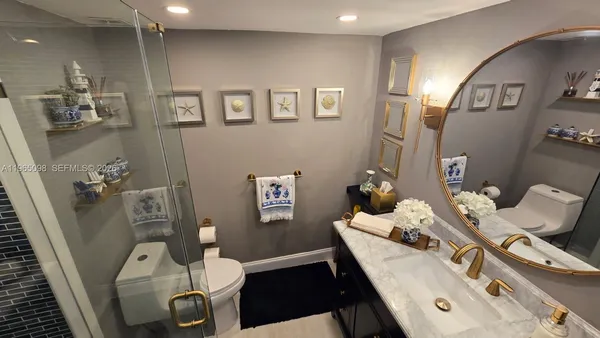 a bathroom with a sink vanity mirror and tub