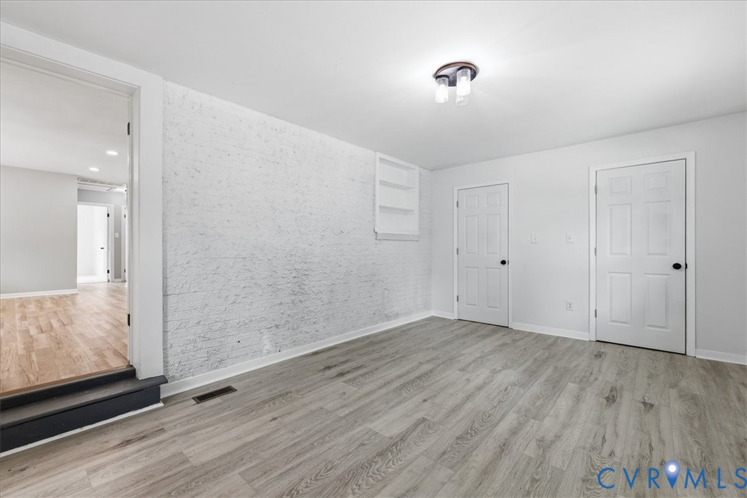 5306 Sterling Road Petersburg, VA 23803 - Photo 12 of 39 a view of an empty room with wooden floor and a bathroom