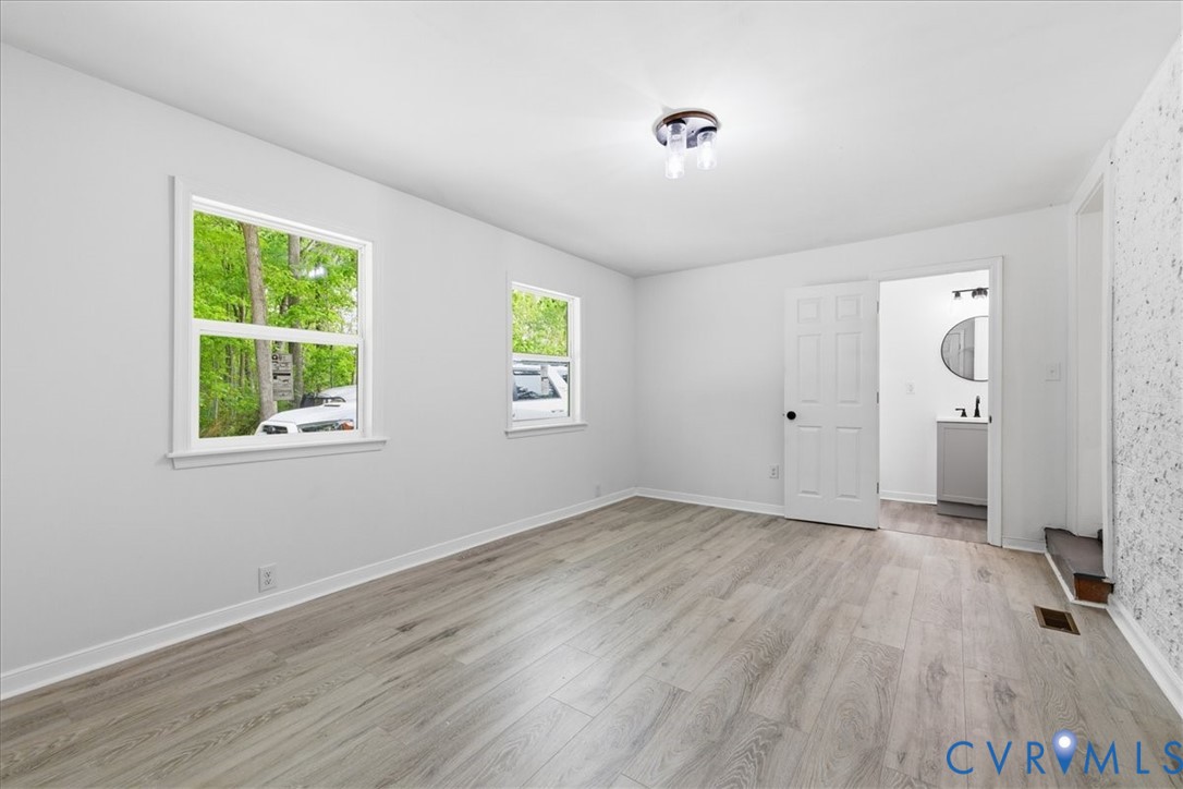 5306 Sterling Road Petersburg, VA 23803 - Photo 14 of 39 a view of an empty room with wooden floor and a window