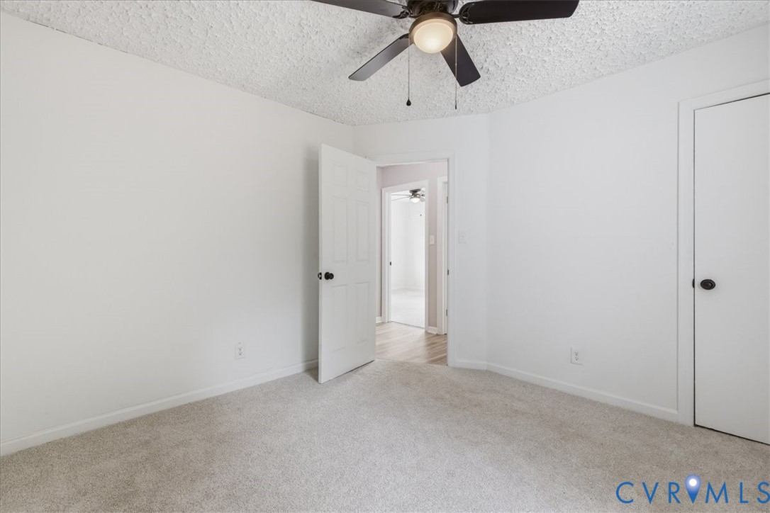 5306 Sterling Road Petersburg, VA 23803 - Photo 21 of 39 an empty room with chandelier fan