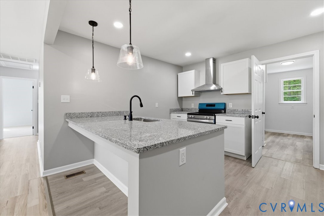 5306 Sterling Road Petersburg, VA 23803 - Photo 8 of 39 a kitchen with stainless steel appliances granite countertop a sink a stove and a refrigerator