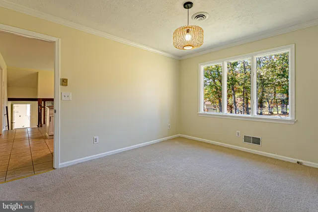 an empty room with windows and entrance
