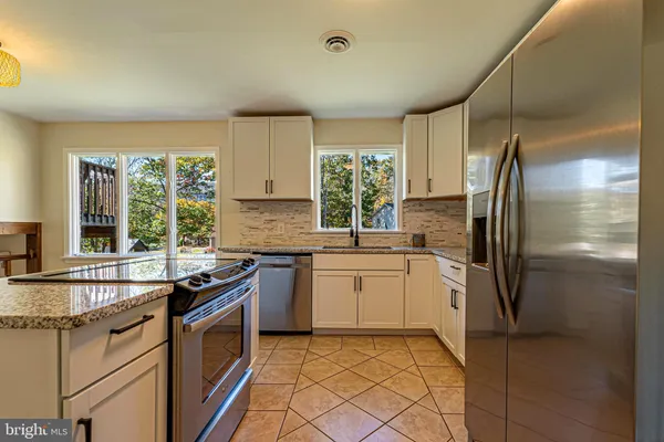 a kitchen with a sink stove and refrigerator
