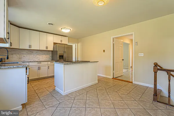 a kitchen with a sink a counter top space and cabinets