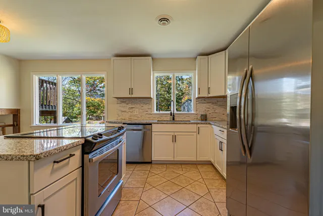 a kitchen with a sink stove and refrigerator
