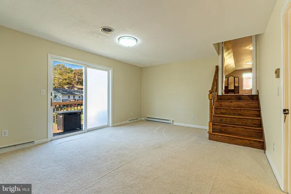an empty room with fireplace and windows