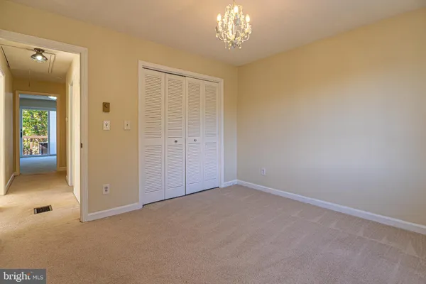a view of an empty room with a chandelier
