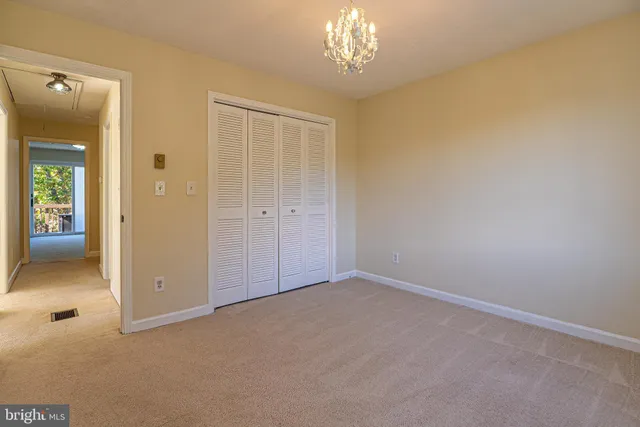 a view of an empty room with a chandelier