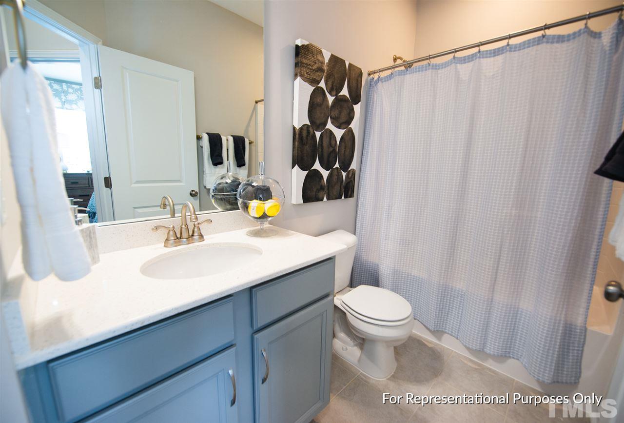 3640 Water Mist Lane, Unit 44 Raleigh, NC 27604 - Photo 14 of 20 a bathroom with a sink a toilet and shower curtain
