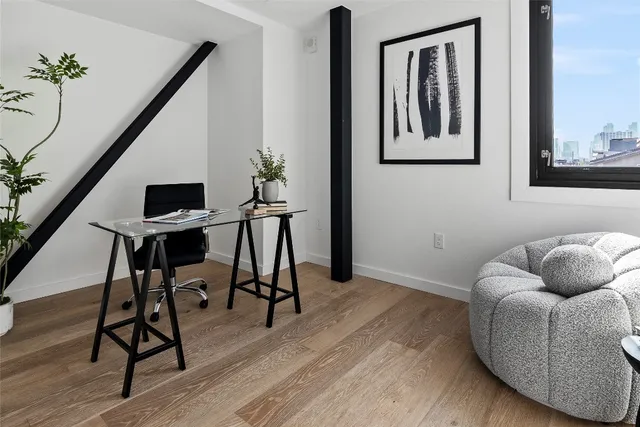a workspace with furniture and wooden floor